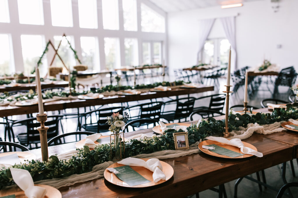 Long tables decorated for a wedding reception at The Atrium in Branson, Missouri. This is an example of a wedding detail shot.