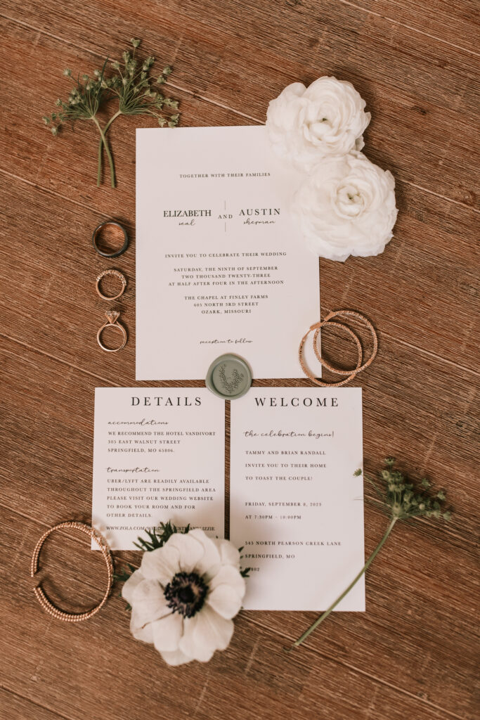 Rings, invitations, and bridal jewelry for a black tie wedding at Finley Farms wedding venue