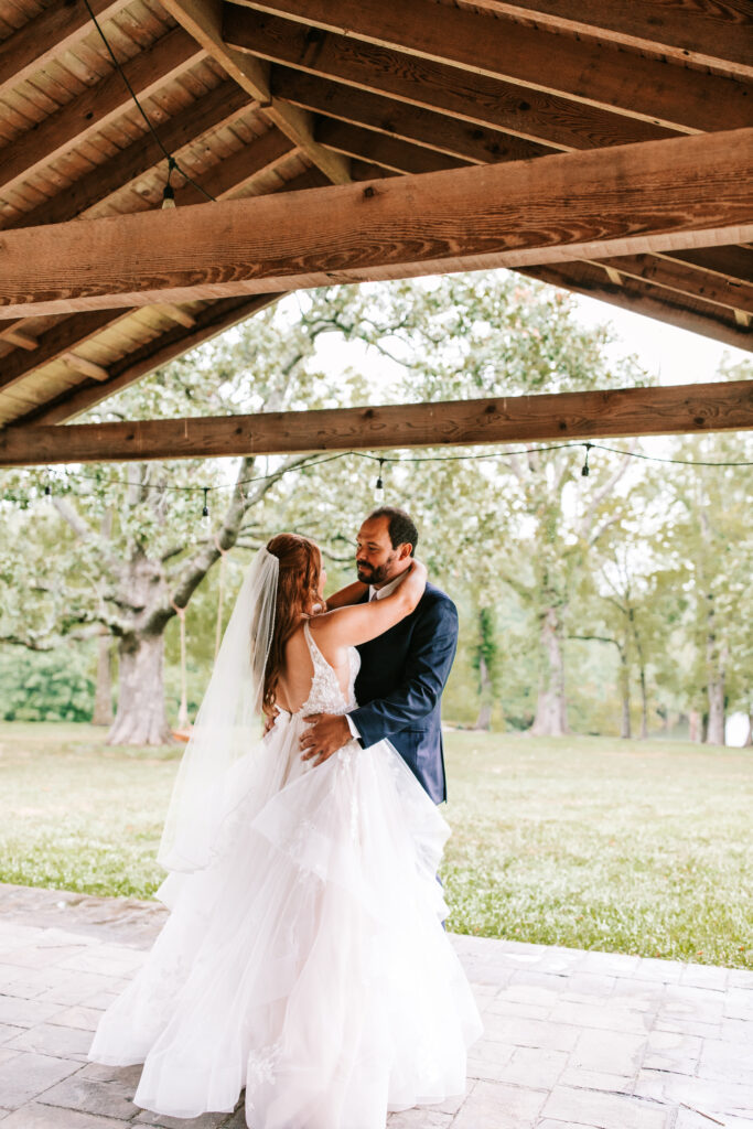 Bride and groom dancing under the covered patio in Lebanon, Missouri.
