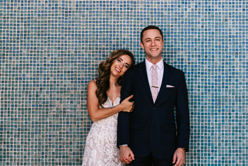 Bride and groom in front of a blue tile wall in Kansas City, Missouri photographed by Bailey Morris wedding photography.