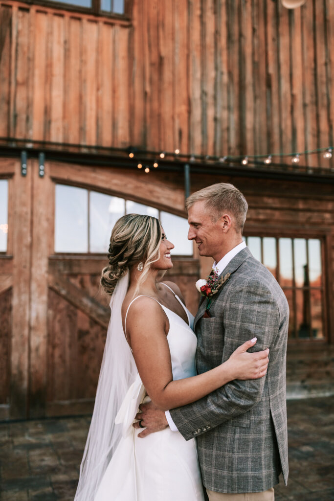 Bride and groom looking into each others eyes on the outdoor patio at their Lebanon, Missouri wedding venue.