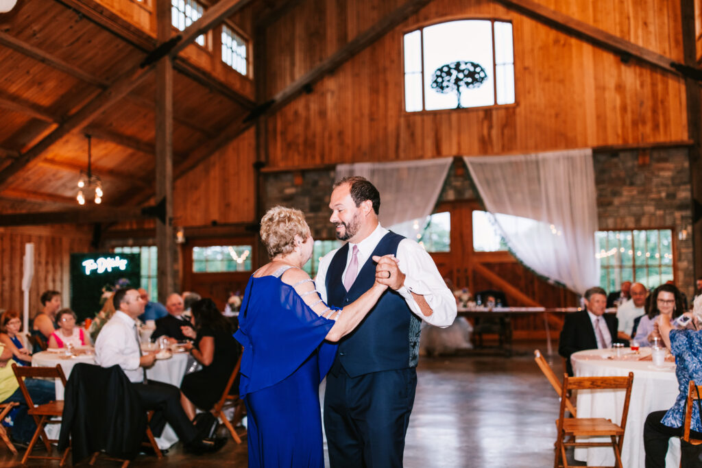 Groom dancing with his mother at his wedding reception at Mighty Oak Lodge in Lebanon, Missouri.
