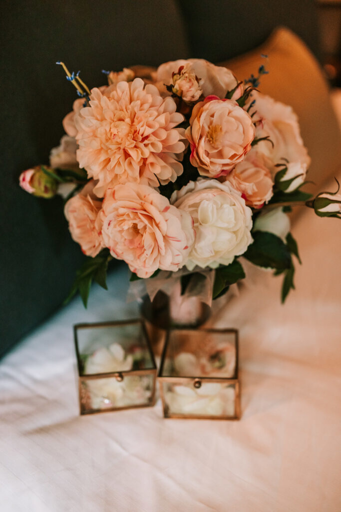 A bouquet of peach and cream flowers as an example of spring wedding season florals photographed by Bailey Morris Photography.

