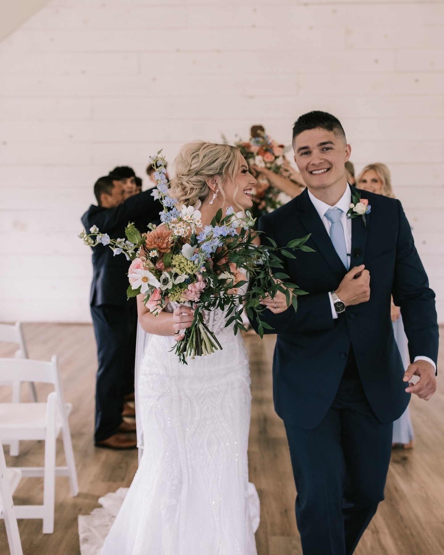 Bride and groom newly married walking out of the chapel at Sparrow Lane Wedding Venue. Photography by Bailey Morris Wedding Photography.