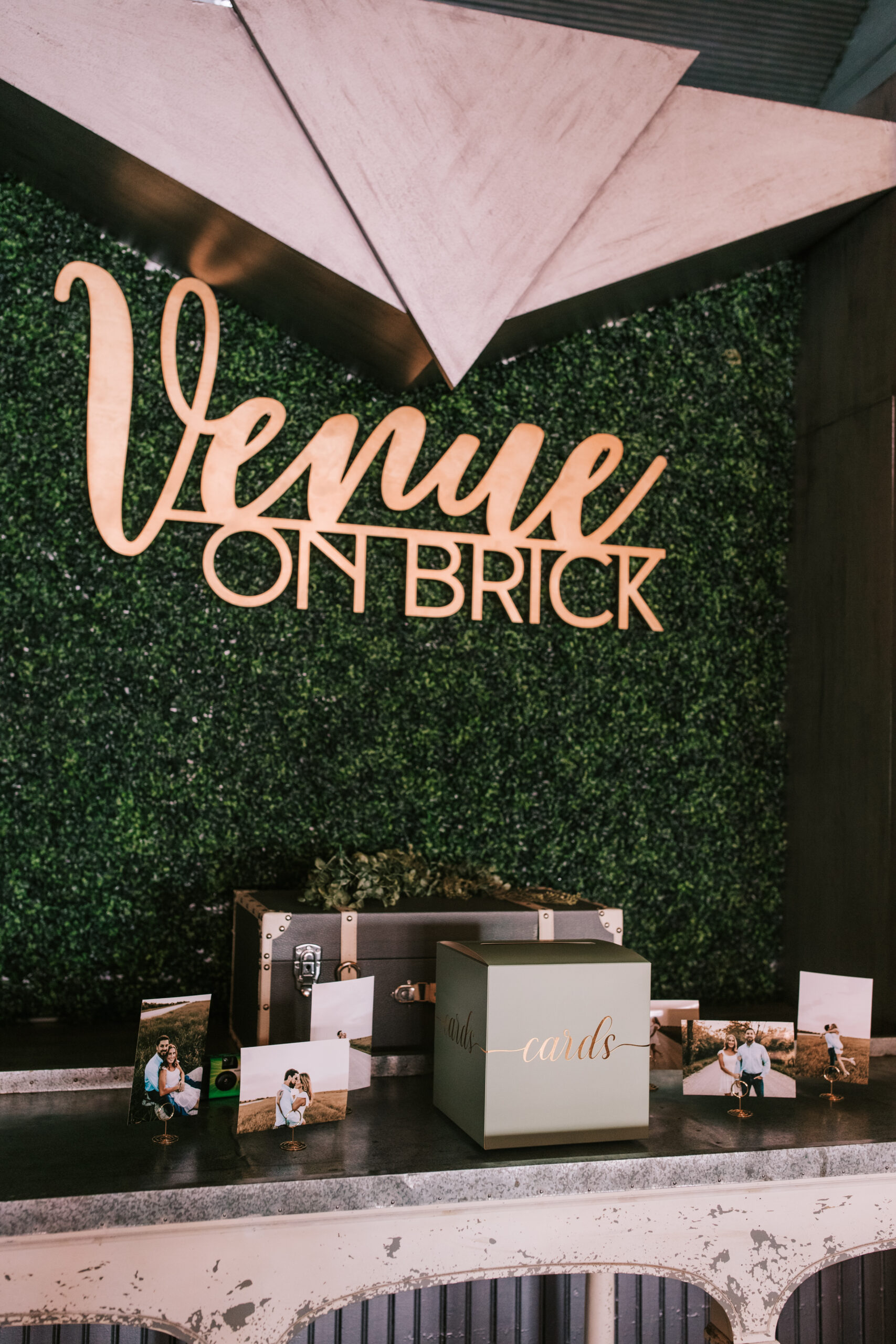 Copper sign against faux green wall at Venue on Brick.