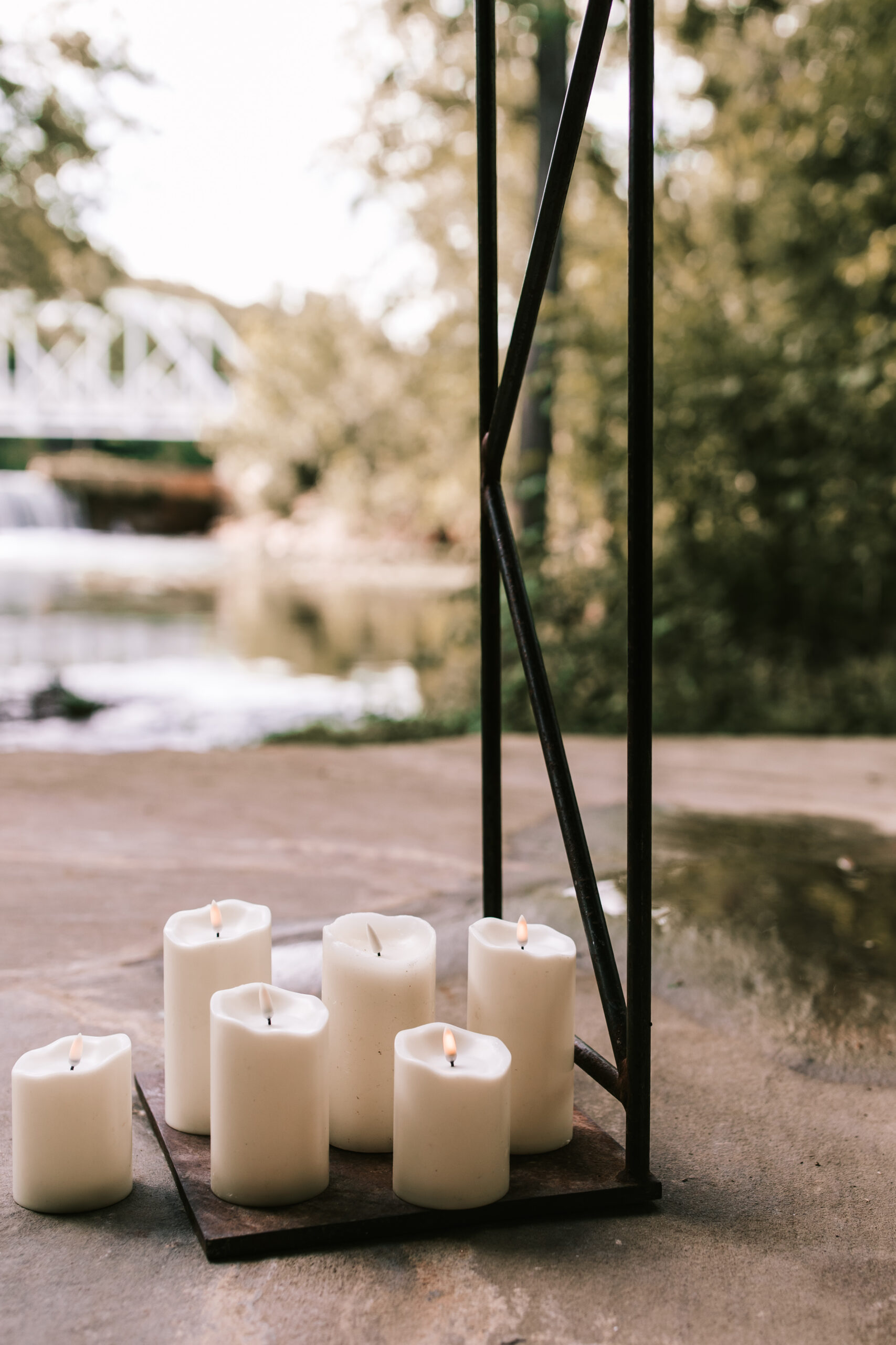 6 lit candles serve as decoration at a wedding in The Chapel at Finley Farms wedding venue in Ozark, Missouri. 