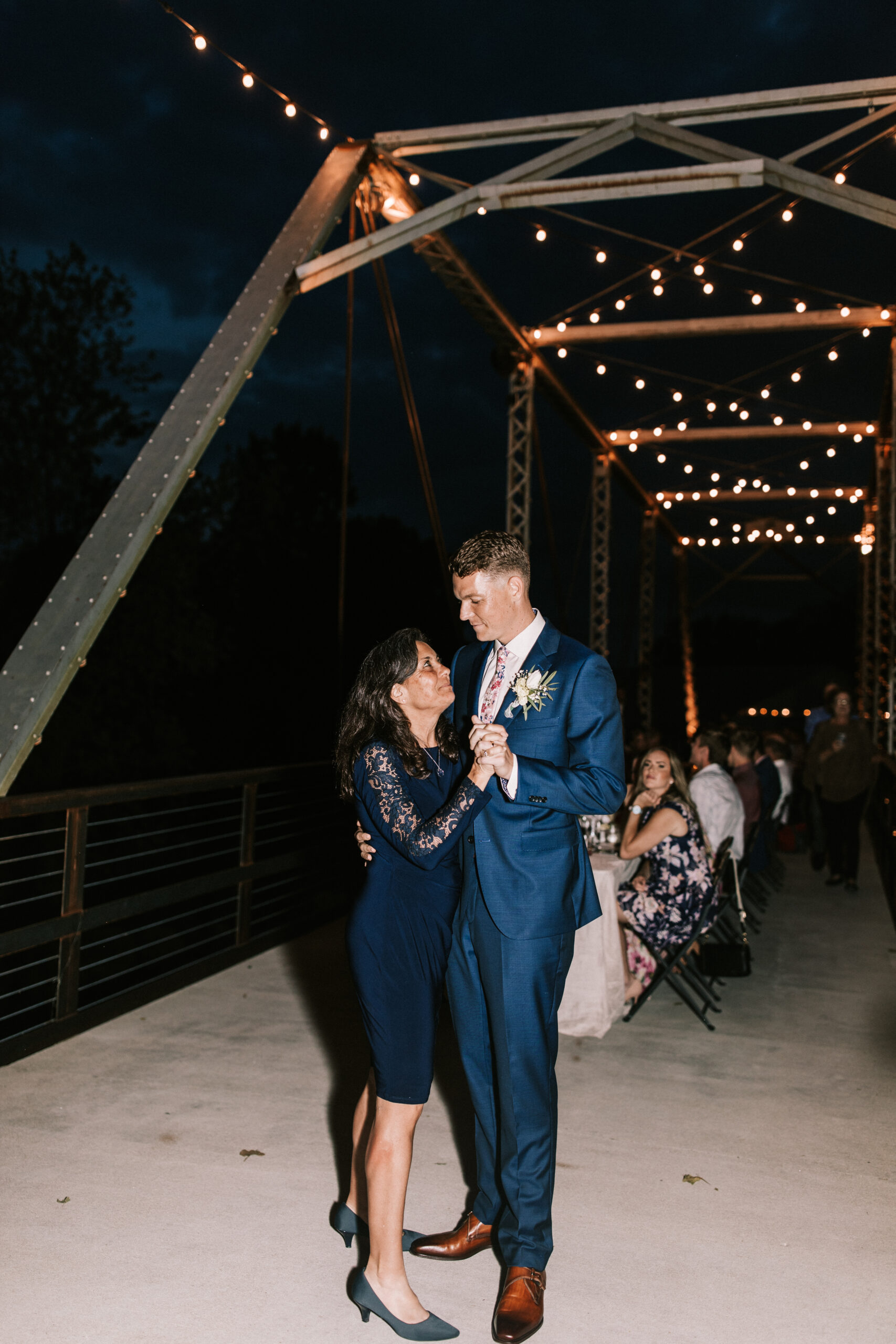 Groom dancing with his mother on the Riverside Bridge at Finley Farms.