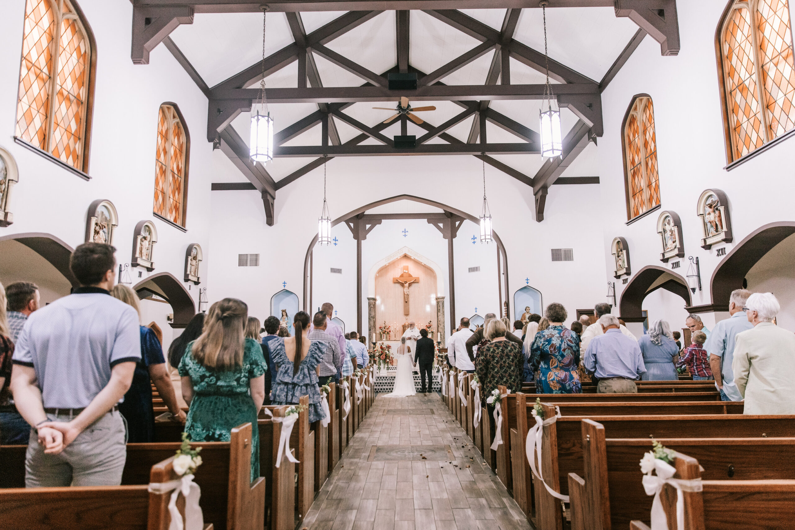 Guests watch as a young couple gets married at St. Francis DeSales Catholic Church in Lebanon, Missouri.